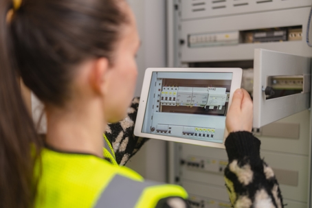 technician inspecting electric panel