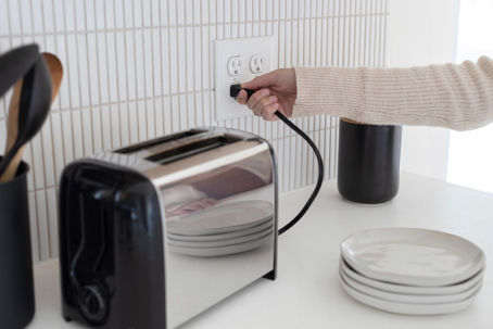 homeowner plugging/unplugging a toaster